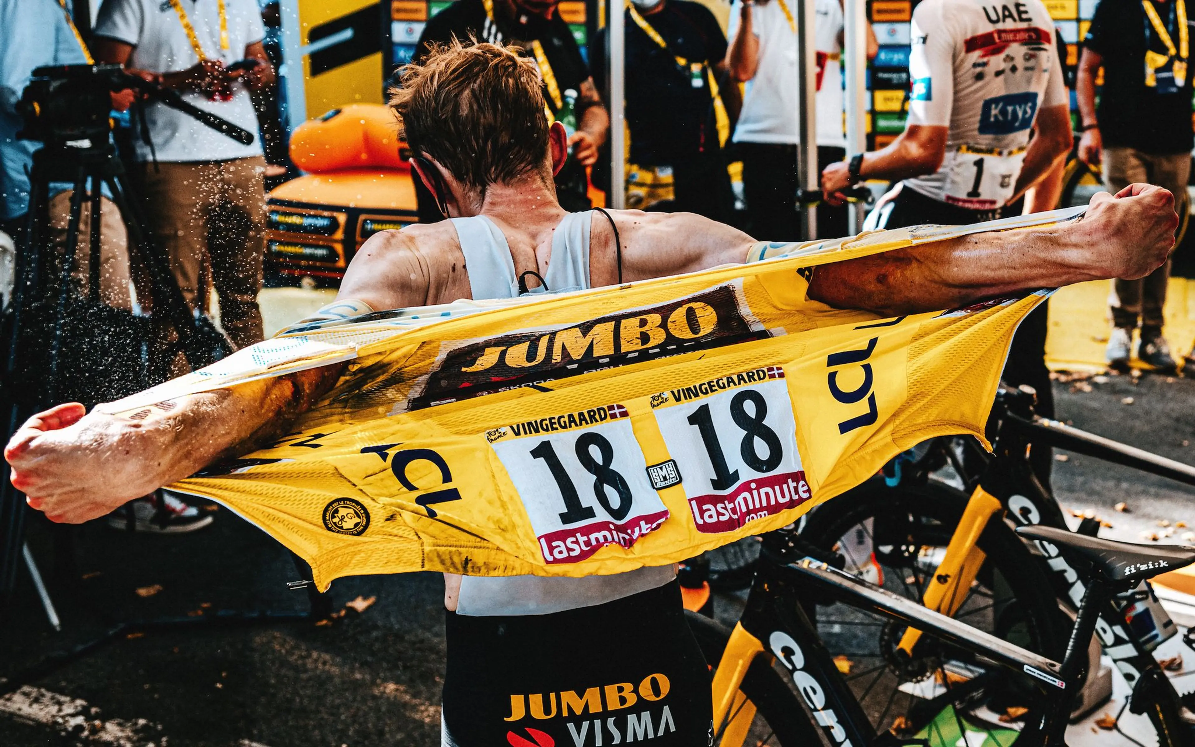 Vingegaard removes his slightly damaged yellow jersey after a crash on Stage 15.
