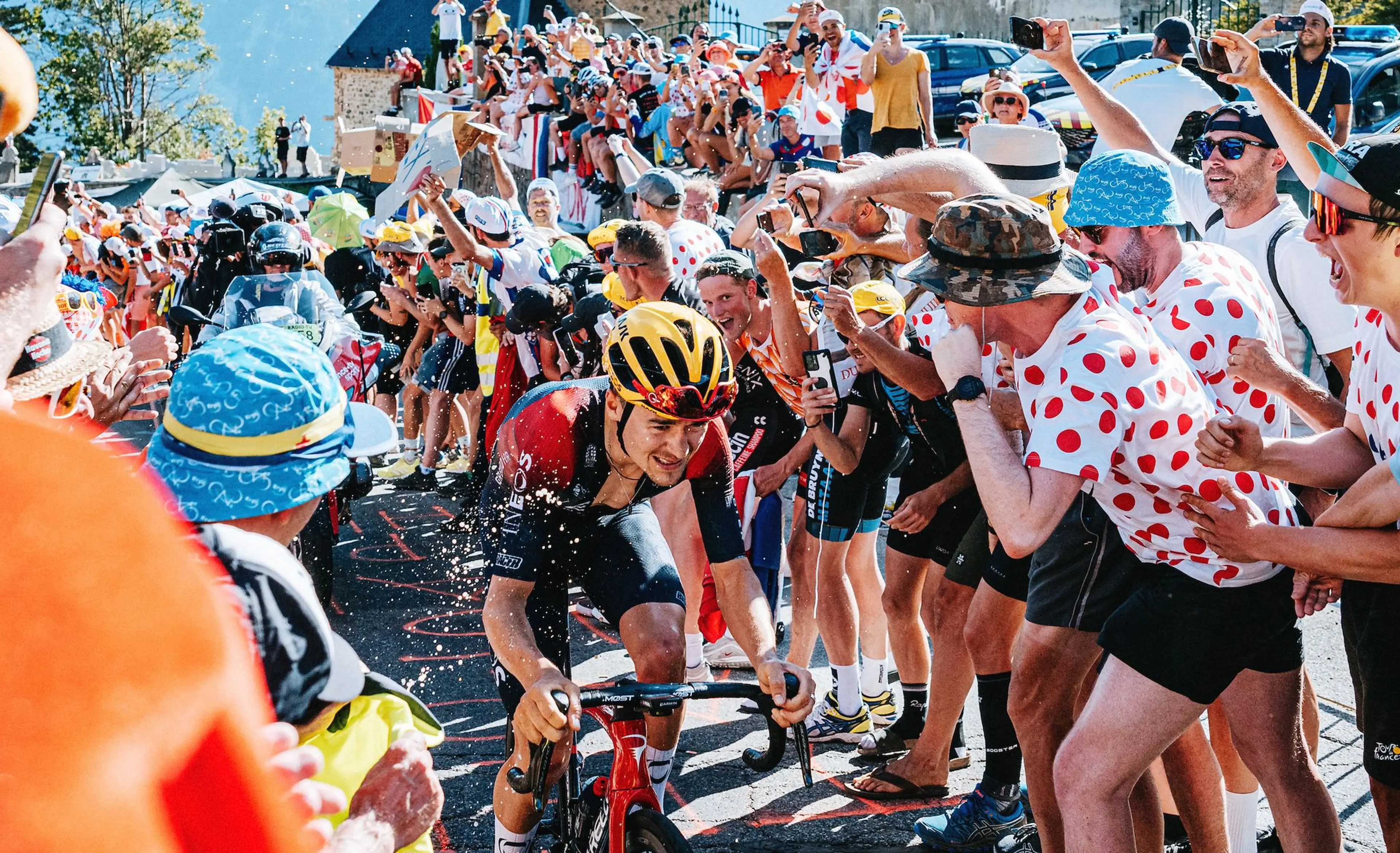 Tom Pidcock (Ineos Grenadiers) gets splashed by a fan during his ascent of Alpe d’Huez. He’d go on to win Stage 12 at the top of the legendary climb.